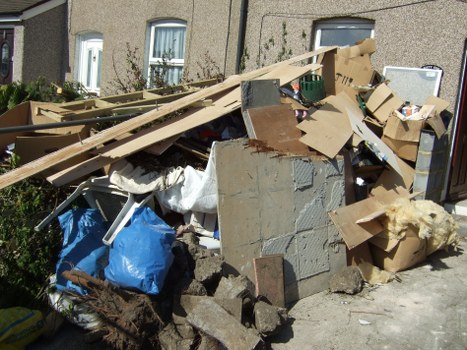 Waste clearance vehicle removing construction debris in Hammersmith